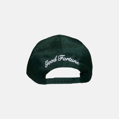 Forest Green Trucker Hat with a White Logo on the Front, Adjustable Strap, Curved Brim, and Good Fortune curved in the back